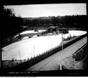 below we see a stone bridge leading to what is variously known as the Island House or the Monkey House in the middle of a pond. All still exist.   1921